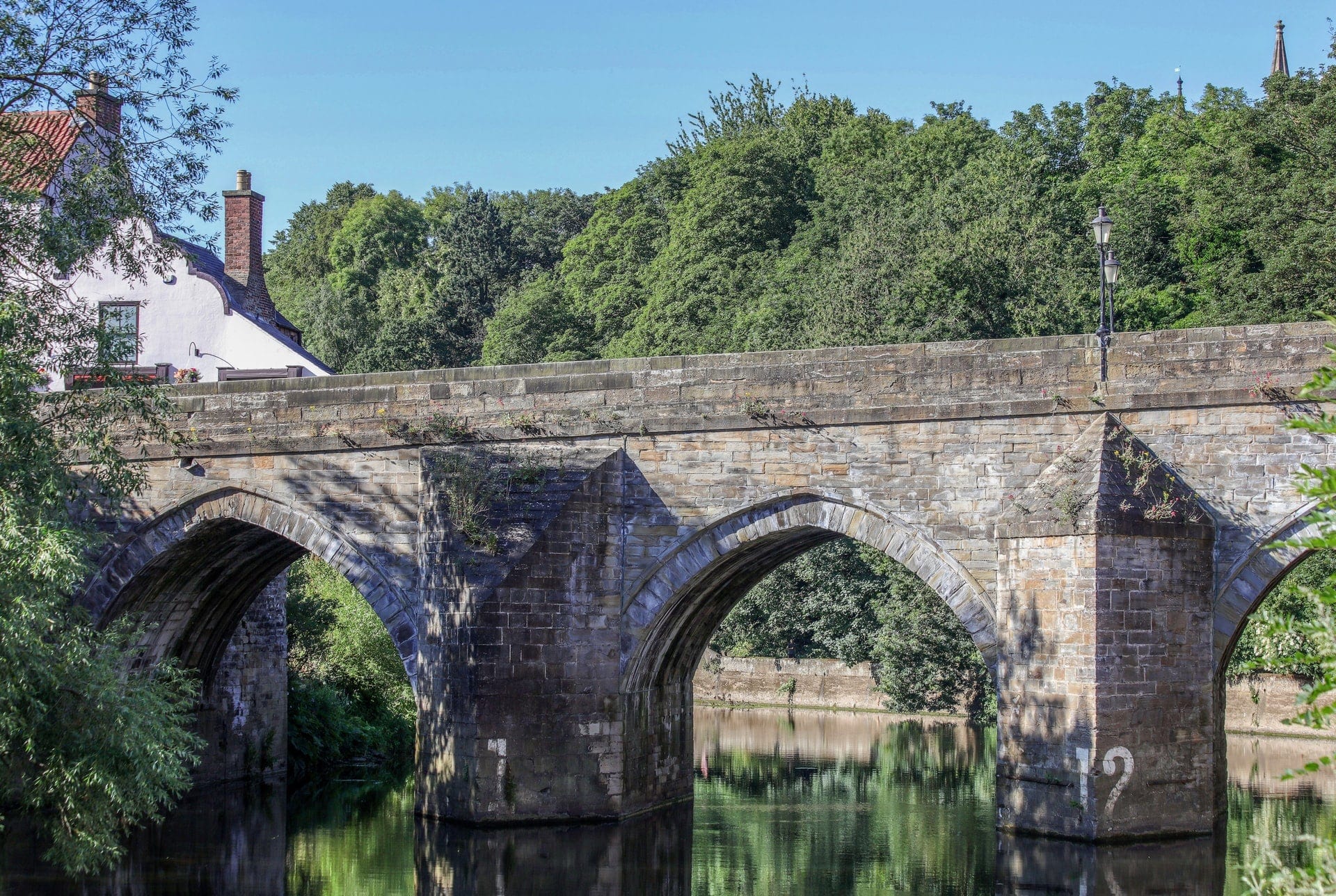 bridge-going-over-river-with-trees-in-background-in-durham