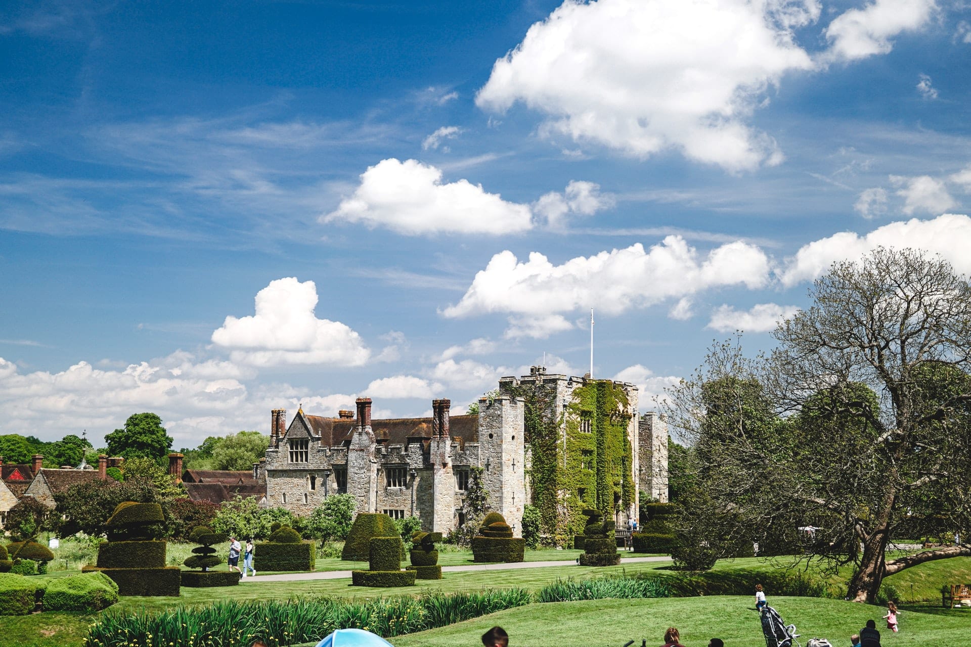 people-exploring-castle-on-summers-day-hever-castle-kent-day-trips-from-brighton