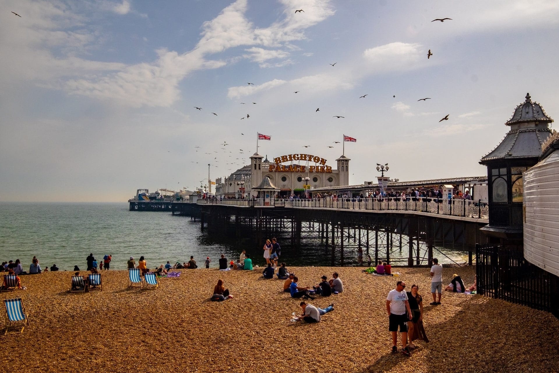 people-on-beach-by-pier-on-summers-day-brighton-day-trips-from-london-by-car